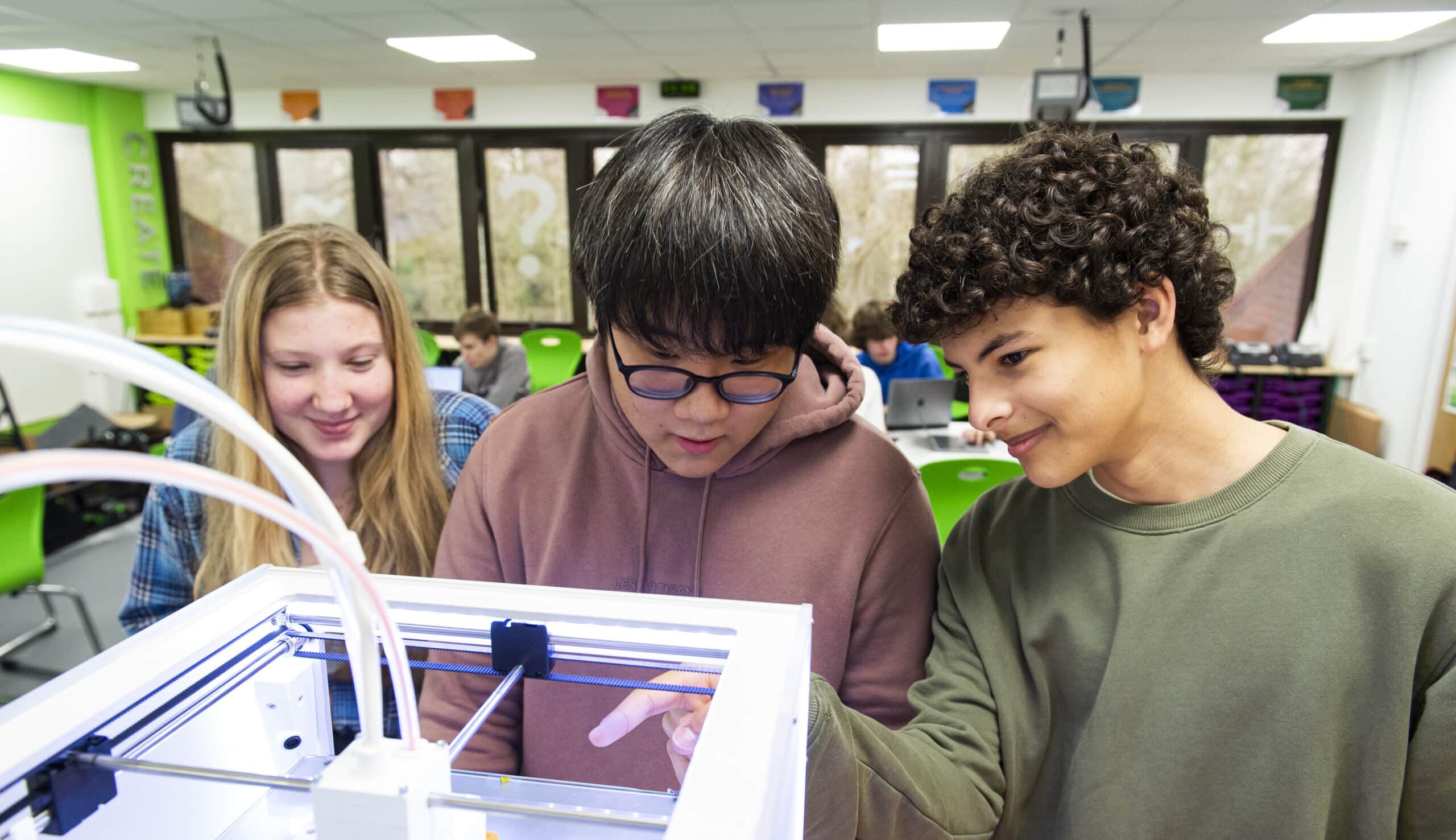 ACS Cobham senior pupils working with a 3D printer in the STEM centre
