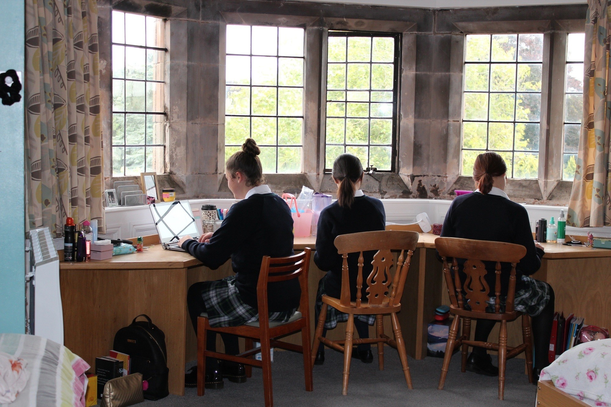 Adcote boarders studying at desks in a boarding bedroom