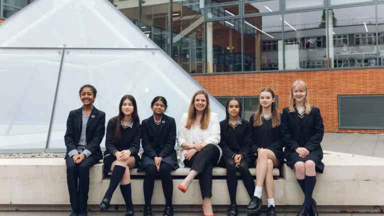 Group seated outside a modern building