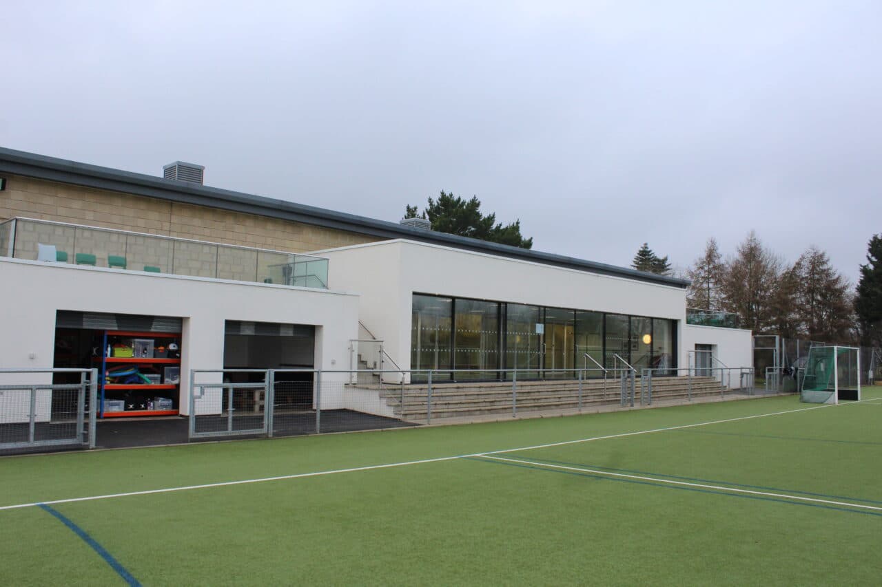 The Dewey sports building and hockey pitch at Bloxham School