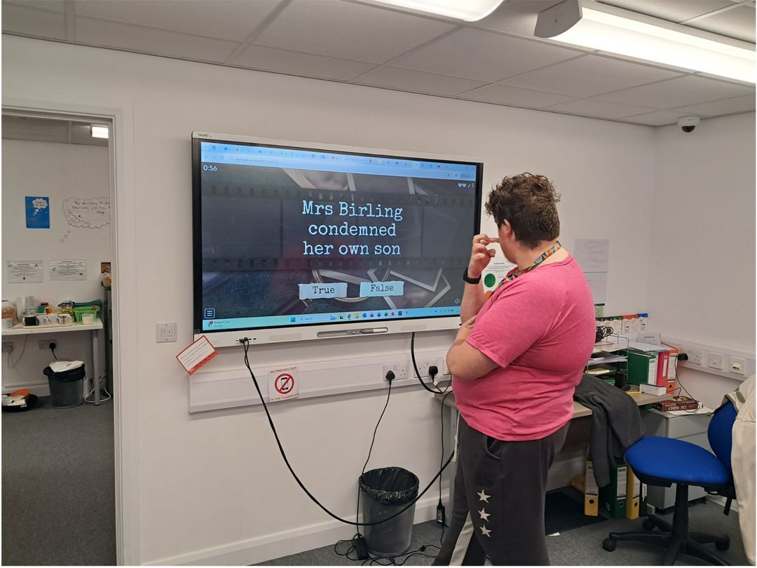 student looking at board doing English