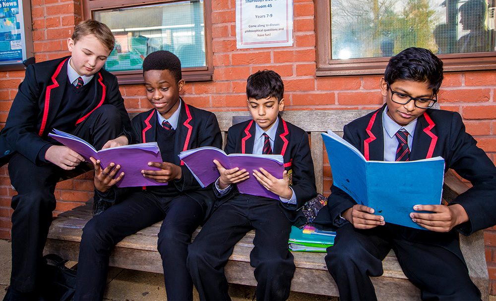 King Edward VI Grammar School pupils reading outdoors