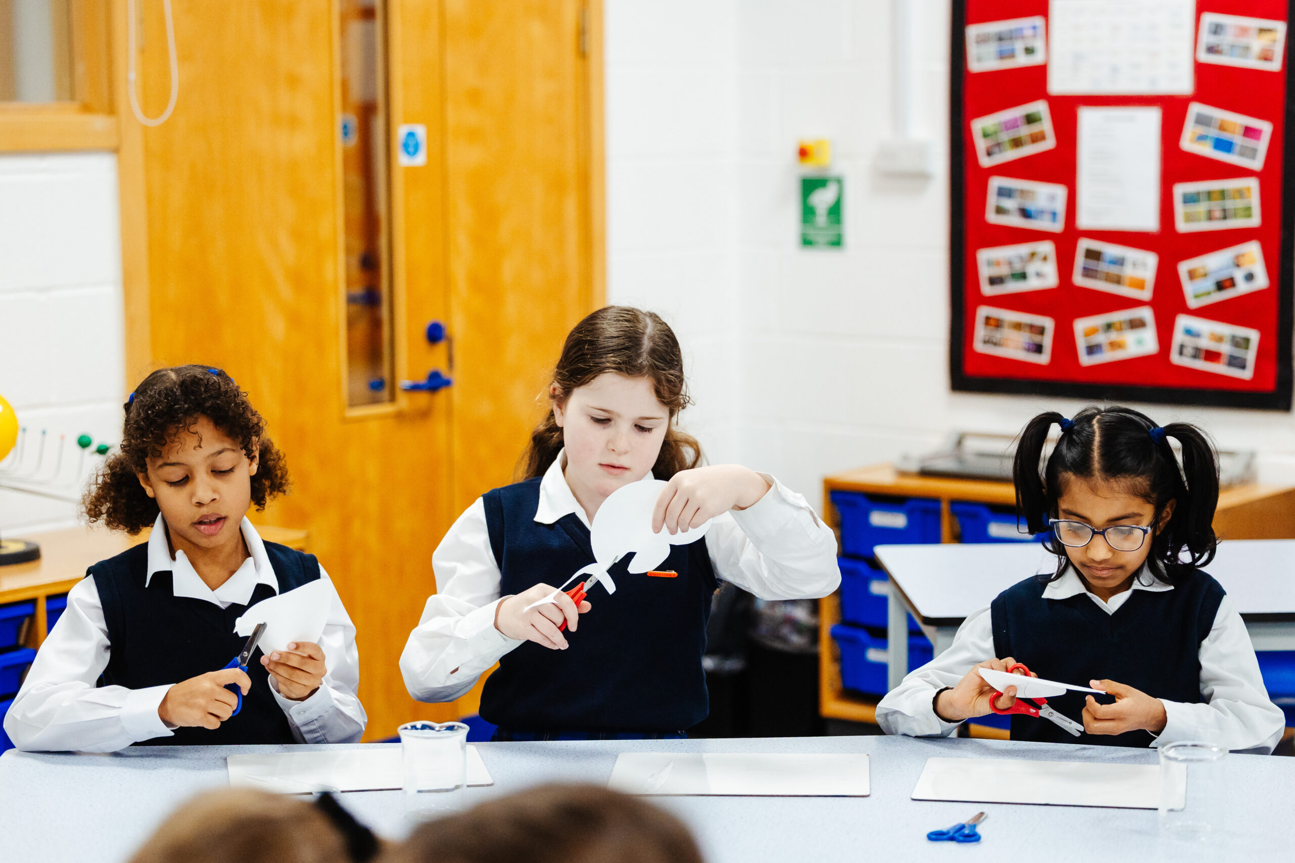 three Junior School pupils participate in a science lesson at Northampton High School