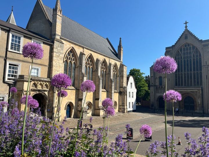 A church with purple flowers in front of it