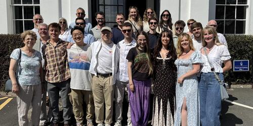 Group photo of alumni students outside the main Sidcot private school building in Somerset near Bristol