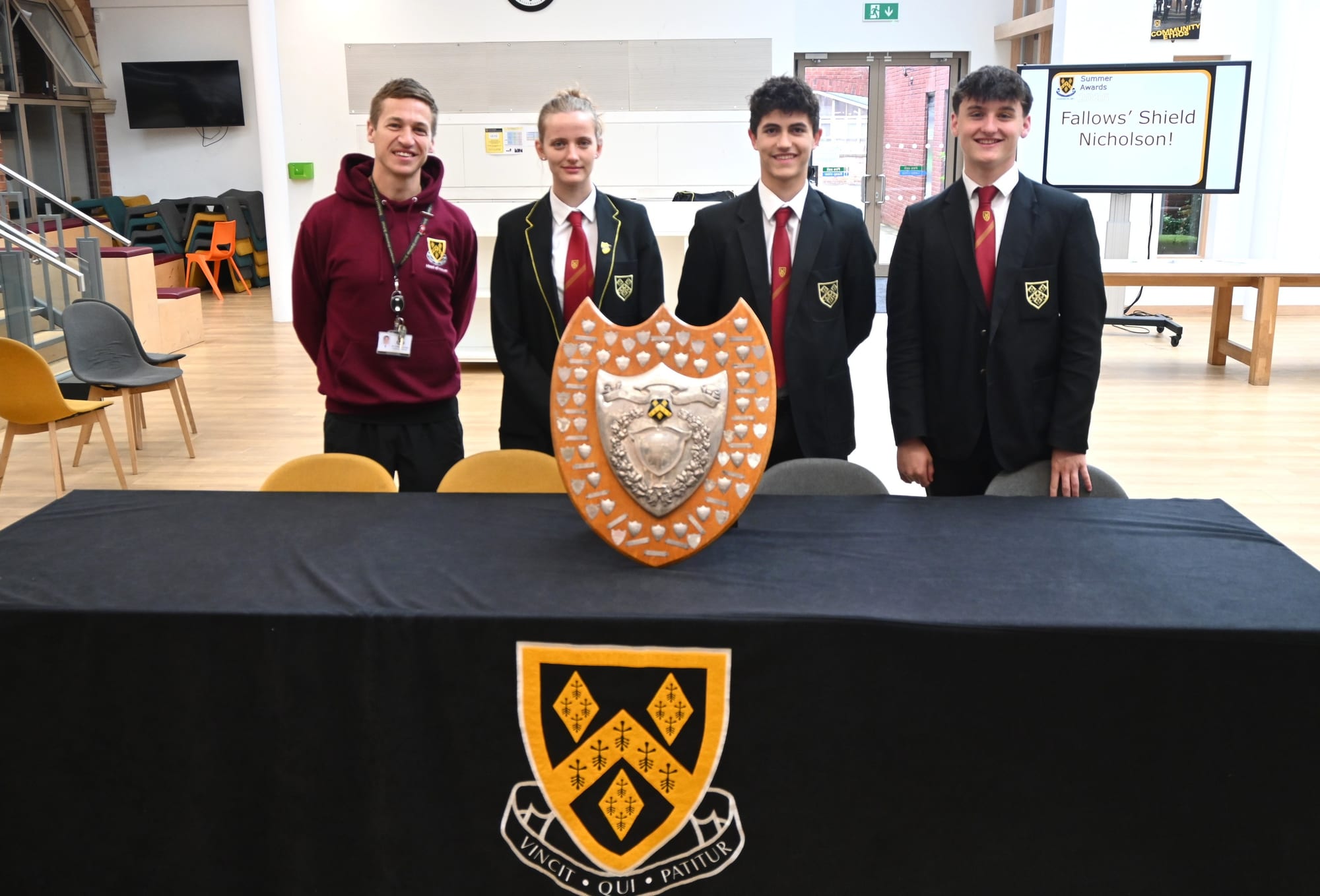 Three Nicholson House Captains and Mr Buxton-Cope pose with the Fallows' Shield after winning the trophy for the 2025-2026 academic year